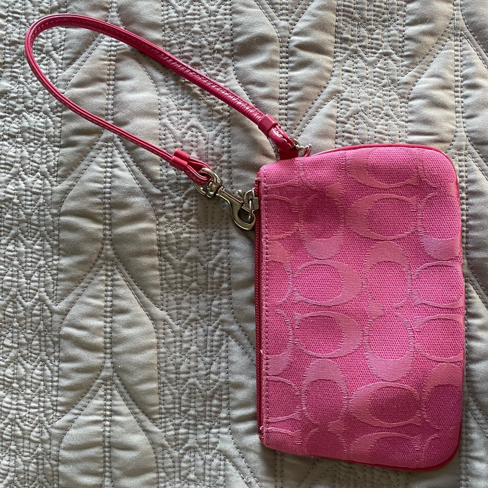 Coach wristlet in classic pink pattern